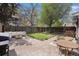 Cozy backyard with an outdoor seating area, brick-paved patio, lush lawn, and privacy fence at 5250 Cody St, Arvada, CO 80002