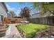 A beautiful backyard with patio, a manicured lawn, and privacy fencing perfect for entertaining and relaxation at 5250 Cody St, Arvada, CO 80002