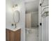 Stylish bathroom with a modern vanity, oval mirror, and tub-shower featuring gray subway tile at 5250 Cody St, Arvada, CO 80002