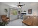Inviting bedroom with a ceiling fan, large window, built-in desk and comfortable seating at 5250 Cody St, Arvada, CO 80002