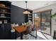 Stylish dining area with built-in shelving, modern lighting, and sliding glass door to patio at 5250 Cody St, Arvada, CO 80002