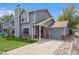 Charming gray two-story home with brick accents, attached garage, and well-manicured lawn at 5250 Cody St, Arvada, CO 80002
