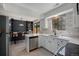 Open kitchen flows into a dining area with a modern design and stainless steel appliances at 5250 Cody St, Arvada, CO 80002