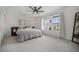 Spacious bedroom with neutral carpet, light-filled windows, and a comfortable bed at 5250 Cody St, Arvada, CO 80002