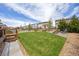 Well-maintained backyard with a lush lawn, fire pit, and seating area perfect for outdoor enjoyment at 11048 Rifle Ct, Commerce City, CO 80022