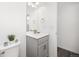 A pristine powder room with white walls, sleek vanity, modern fixtures, and well-placed lighting at 11048 Rifle Ct, Commerce City, CO 80022