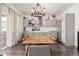 This dining room features modern gray cabinets, a large wooden dining table, and a view of the backyard at 11048 Rifle Ct, Commerce City, CO 80022