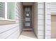 Close-up of a stylish front door with glass panels and a welcoming wreath at 11048 Rifle Ct, Commerce City, CO 80022