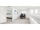 Upstairs hallway featuring a view into the bedroom, and a work area, featuring natural light and neutral carpet at 11048 Rifle Ct, Commerce City, CO 80022