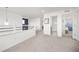 Light-filled hallway with access to a bathroom and bedroom, features neutral paint and plush carpeting at 11048 Rifle Ct, Commerce City, CO 80022