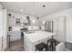 Bright kitchen featuring modern island, sleek countertops and stainless steel appliances at 11048 Rifle Ct, Commerce City, CO 80022