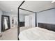Spacious main bedroom with a four-poster bed and views into a walk-in closet at 11048 Rifle Ct, Commerce City, CO 80022
