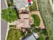 Aerial view showcasing a landscaped backyard with a stone patio, lush lawn, and cozy seating, highlighting the home's outdoor charm at 4963 Collingswood Dr, Highlands Ranch, CO 80130