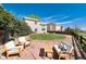 Landscaped backyard with stone patio, plush lawn, and seating area, perfect for outdoor relaxation and entertaining at 4963 Collingswood Dr, Highlands Ranch, CO 80130