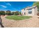 Expansive backyard featuring a deck with furniture and a large lawn surrounded by rock landscaping at 4963 Collingswood Dr, Highlands Ranch, CO 80130