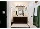 Bathroom featuring a double sink vanity, large mirror, and clean white accents at 4963 Collingswood Dr, Highlands Ranch, CO 80130