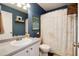 Traditional bathroom featuring vanity, toilet, and shower/tub with decorative shower curtain at 4963 Collingswood Dr, Highlands Ranch, CO 80130
