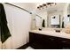 Bathroom featuring a double sink vanity, large mirror, and shower with curtain at 4963 Collingswood Dr, Highlands Ranch, CO 80130