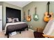 Cozy bedroom displaying guitar decor on the walls, neutral carpet, and light green walls at 4963 Collingswood Dr, Highlands Ranch, CO 80130
