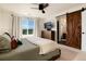 Bedroom featuring a sliding barn door, large window with views, and a TV at 4963 Collingswood Dr, Highlands Ranch, CO 80130