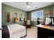 This stylish bedroom features a ceiling fan, guitars on the wall, and a workspace with a window at 4963 Collingswood Dr, Highlands Ranch, CO 80130