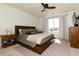 Comfortable bedroom with a large window, wood furniture, and neutral decor at 4963 Collingswood Dr, Highlands Ranch, CO 80130