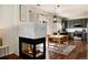 Cozy dining area with a fireplace, wood floors, and modern lighting at 4963 Collingswood Dr, Highlands Ranch, CO 80130