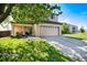 Charming two-story home features a covered porch with seating and a well-manicured lawn at 4963 Collingswood Dr, Highlands Ranch, CO 80130