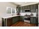 Modern kitchen with green cabinetry, white countertops, and stainless steel appliances at 4963 Collingswood Dr, Highlands Ranch, CO 80130