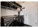 Well-organized laundry room featuring modern washer/dryer, shelving, and a tiled floor at 4963 Collingswood Dr, Highlands Ranch, CO 80130