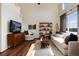 Cozy living room with a high ceiling, hardwood floors and lots of natural light at 4963 Collingswood Dr, Highlands Ranch, CO 80130