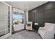 Cozy home office space with black accent wall, lots of natural light, and modern furnishings at 14450 Forest St, Thornton, CO 80602