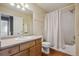 This bathroom features a vanity, toilet and a shower-tub combo with a white shower curtain at 13271 Holly St # D, Thornton, CO 80241