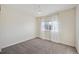 Bedroom with neutral walls, carpet, and a window with sheer curtains at 13271 Holly St # D, Thornton, CO 80241