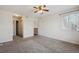 Bright, carpeted bedroom features neutral walls and a ceiling fan, with natural light at 13271 Holly St # D, Thornton, CO 80241