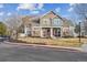 Two-story townhome featuring stone accents, a red front door, and a well-maintained front lawn at 13271 Holly St # D, Thornton, CO 80241