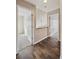 Hallway with hardwood flooring leading to carpeted bedrooms through open doors at 13271 Holly St # D, Thornton, CO 80241