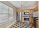 Updated kitchen with stainless steel appliances, checkerboard tile floors, and window at 13271 Holly St # D, Thornton, CO 80241