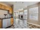 View from the kitchen into the open living room, showing tile and wood floors at 13271 Holly St # D, Thornton, CO 80241
