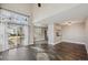 Open living room with high ceilings, wood floors, and large windows and sliding glass doors to the patio at 13271 Holly St # D, Thornton, CO 80241