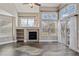 Bright living room with hardwood floors, large windows, fireplace, and modern ceiling fan at 13271 Holly St # D, Thornton, CO 80241