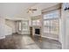 Bright living room with hardwood floors, fireplace, and large windows letting in plenty of natural light at 13271 Holly St # D, Thornton, CO 80241