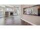 Open living room with a fireplace, built-in shelving and large windows with natural light at 13271 Holly St # D, Thornton, CO 80241