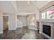 Bright living room with hardwood floors and a cozy fireplace, showcasing the home's interior design at 13271 Holly St # D, Thornton, CO 80241