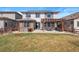 Spacious backyard featuring a well-maintained lawn, patio, and wooden pergola perfect for entertaining at 18926 W 93Rd Ave, Arvada, CO 80007