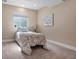 Cozy basement bedroom with a single bed, side table, and a well-lit window at 18926 W 93Rd Ave, Arvada, CO 80007