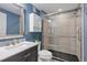 Stylish bathroom featuring a large glass shower enclosure and modern vanity at 18926 W 93Rd Ave, Arvada, CO 80007