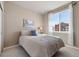 Comfortable bedroom with a soft bed, large window, and neutral decor for relaxation and rest at 18926 W 93Rd Ave, Arvada, CO 80007