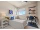 Bright bedroom with natural light, desk, and shelves, creating a cozy and functional space at 18926 W 93Rd Ave, Arvada, CO 80007