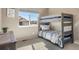 Cozy bedroom featuring a bunk bed, ample sunlight, and space for a playful and restful environment at 18926 W 93Rd Ave, Arvada, CO 80007